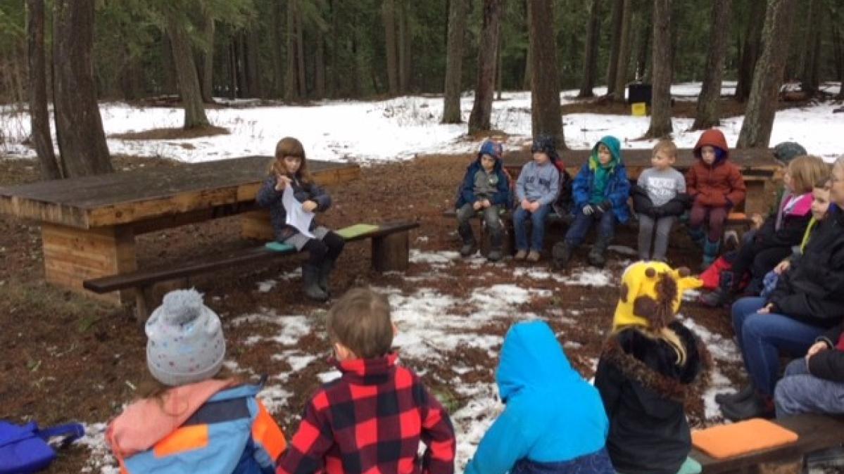 BKE Kindergarten Class engaging in outdoor learning at the outdoor classroom in the forest area of the school. 