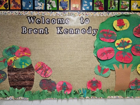 A bulletin board with a tree and flowers</p>
<p>Description automatically generated