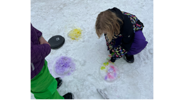 School children make coloured designs on the snow 