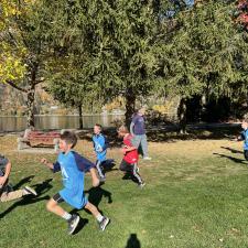 Students mid-stride in a cross-country running event